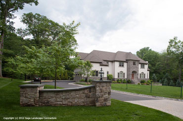 Driveway Entrance with stone pillars and lighting
