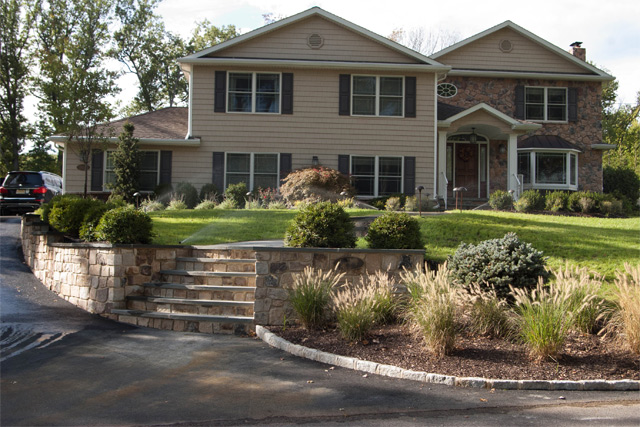 Landscape plantings with retaining wall